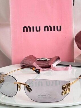 Miu Miu Rimless Sunglasses with Pink-Tinted Lenses and Gold Temples